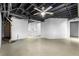 Unfinished basement with exposed ceiling, ready for customization, complemented by a convenient utility sink area at 7316 Caribou Trl, Riverdale, GA 30296