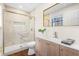 Bathroom features a sleek glass shower, modern vanity, and gold accents for a luxurious feel at 7316 Caribou Trl, Riverdale, GA 30296