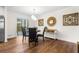 Elegant dining area featuring modern decor and access to the outdoor space, ideal for entertaining guests at 7316 Caribou Trl, Riverdale, GA 30296
