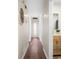 Hallway featuring new floors, modern lighting, and access to a stylish half bathroom with wood vanity at 7316 Caribou Trl, Riverdale, GA 30296