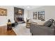 Cozy living room with a stone fireplace, large windows, and modern decor accents, creating a warm atmosphere at 7316 Caribou Trl, Riverdale, GA 30296