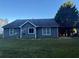 A view of the back of the house with a covered carport and an expansive lawn at 1007 Billy Mcgee Rd, Lawrenceville, GA 30045