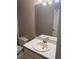 Well-lit bathroom featuring a sink, mirror and toilet, offering functionality and comfort at 1007 Billy Mcgee Rd, Lawrenceville, GA 30045