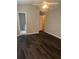 Bedroom with hardwood floors, ceiling fan, and view to ensuite bathroom at 1007 Billy Mcgee Rd, Lawrenceville, GA 30045