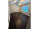 Bedroom with wood-look flooring, neutral walls, and a bright window at 1007 Billy Mcgee Rd, Lawrenceville, GA 30045