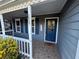 Charming front porch with painted blue siding, decorative door, and tiled floor at 1007 Billy Mcgee Rd, Lawrenceville, GA 30045