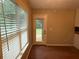 Bright living room featuring hardwood floors, a large window, and a door to the backyard at 1007 Billy Mcgee Rd, Lawrenceville, GA 30045