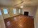 Inviting living room with hardwood floors, fireplace, ceiling fan, and ample natural light at 1007 Billy Mcgee Rd, Lawrenceville, GA 30045