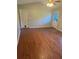 Open-concept living room with hardwood flooring and natural light featuring two entry doors and a ceiling fan at 1007 Billy Mcgee Rd, Lawrenceville, GA 30045