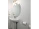 Clean, minimalist bathroom with a pedestal sink and an oval mirror at 1312 Stanley Park Dr, Decatur, GA 30033
