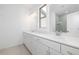 Bright bathroom featuring double vanity, white cabinets, gold hardware, and a large mirror at 1312 Stanley Park Dr, Decatur, GA 30033