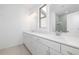 Bright bathroom featuring double vanity, marble countertop, and modern gold fixtures at 1312 Stanley Park Dr, Decatur, GA 30033