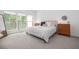 Relaxing bedroom shows a large bed, soft carpet, bedside tables, and leafy green scenery at 1312 Stanley Park Dr, Decatur, GA 30033