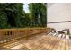 Wooden deck with seating area, striped outdoor rug, and view of trees at 1312 Stanley Park Dr, Decatur, GA 30033