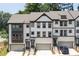 Townhome exterior shows eye-catching black-and-white trim, brick base, and attached garages at 1312 Stanley Park Dr, Decatur, GA 30033
