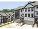 Exterior view of new townhouses with garage, white and black trim, and landscaped grounds at 1312 Stanley Park Dr, Decatur, GA 30033