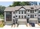 New townhouse exterior with white brick, garage, black trim, and professionally landscaped walkway at 1312 Stanley Park Dr, Decatur, GA 30033