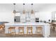 Modern kitchen features a large island, stainless steel appliances, and stylish pendant lighting at 1312 Stanley Park Dr, Decatur, GA 30033