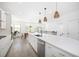 Bright, white kitchen with stainless appliances, quartz countertop, and modern lighting fixtures at 1312 Stanley Park Dr, Decatur, GA 30033