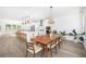 Open concept living space with hardwood flooring, white walls, and kitchen and dining room view at 1312 Stanley Park Dr, Decatur, GA 30033