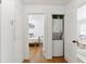 Hallway with laundry closet, white walls, and hardwood floors at 1995 Sumter Nw St, Atlanta, GA 30318