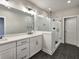 Bathroom featuring modern vanity, glass shower and dark tile floors at 2461 Sycamore Nw Rd, Atlanta, GA 30318