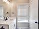 Bathroom featuring a modern vanity, window with blinds, and dark hardware at 2461 Sycamore Nw Rd, Atlanta, GA 30318