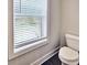 Close up of a bathroom featuring a toilet next to a window with blinds at 2461 Sycamore Nw Rd, Atlanta, GA 30318
