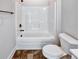Bathroom with dark tile flooring, white shower and white toilet at 2461 Sycamore Nw Rd, Atlanta, GA 30318