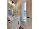 Stylish bathroom featuring a modern vanity, a large mirror, and contemporary fixtures at 2461 Sycamore Nw Rd, Atlanta, GA 30318