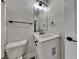 Well-lit bathroom featuring a vanity with a sink, modern fixtures, and a toilet at 2461 Sycamore Nw Rd, Atlanta, GA 30318
