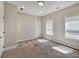 Bedroom with plush carpeting, neutral walls, and natural light from two windows at 2461 Sycamore Nw Rd, Atlanta, GA 30318