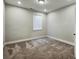 A cozy bedroom with carpet, a window with blinds, and a neutral color scheme at 2461 Sycamore Nw Rd, Atlanta, GA 30318