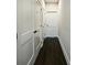 Hallway with dark wood-look floors, modern white doors and neutral paint at 2461 Sycamore Nw Rd, Atlanta, GA 30318