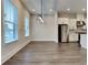 Open concept living space with modern lighting, wood floors, and large windows, perfect for entertaining at 2461 Sycamore Nw Rd, Atlanta, GA 30318