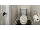 A compact toilet with sleek design, complemented by modern fixtures and neutral walls at 2461 Sycamore Nw Rd, Atlanta, GA 30318