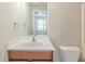 En-suite bathroom with a laminate countertop and a view of the bedroom through a decorative mirror at 2819 Hillside Way, Decatur, GA 30034