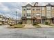 View of townhome exterior featuring attached garages, street view, and manicured front lawns at 2819 Hillside Way, Decatur, GA 30034
