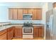 Well-lit kitchen with stainless steel appliances, wooden cabinets and countertop space at 2819 Hillside Way, Decatur, GA 30034