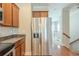 Kitchen with stainless steel appliances, wooden cabinets, and stair access at 2819 Hillside Way, Decatur, GA 30034