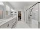 Spacious bathroom featuring double sinks, a walk-in shower, and a view into a walk-in closet at 514 Cunninghame Ct, Peachtree City, GA 30269