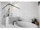 Modern bathroom features a luxurious soaking tub and a sleek glass-enclosed shower with stylish black hardware at 514 Cunninghame Ct, Peachtree City, GA 30269