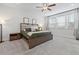 Bedroom featuring neutral carpet and walls with accent furniture and large windows at 514 Cunninghame Ct, Peachtree City, GA 30269
