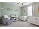 Bedroom with a rocking chair, a changing table, and two cribs at 514 Cunninghame Ct, Peachtree City, GA 30269