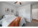 Bright bedroom with a ceiling fan, plush carpet, and double door closet at 514 Cunninghame Ct, Peachtree City, GA 30269