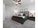 Carpeted bedroom with ceiling fan, nightstands and simple decor at 514 Cunninghame Ct, Peachtree City, GA 30269