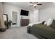 Spacious carpeted bedroom features television, dresser, mirror and ensuite bathroom at 514 Cunninghame Ct, Peachtree City, GA 30269