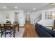 Hallway and dining area with wood floors and view to front door with sidelights and staircase at 514 Cunninghame Ct, Peachtree City, GA 30269