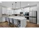 Modern kitchen boasts a center island, stainless appliances, quartz countertops, and white cabinets at 514 Cunninghame Ct, Peachtree City, GA 30269