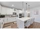 Modern kitchen boasts a center island, stainless appliances, quartz countertops, and white cabinets at 514 Cunninghame Ct, Peachtree City, GA 30269